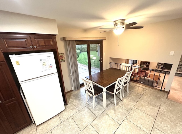 dining space with light tile patterned floors and ceiling fan