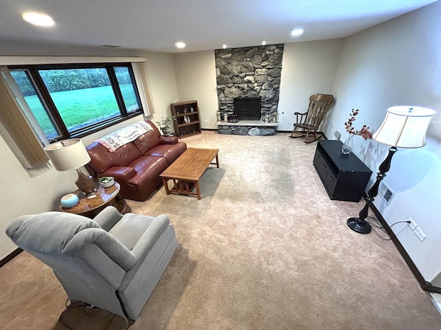 carpeted living area featuring baseboards, a fireplace, and recessed lighting