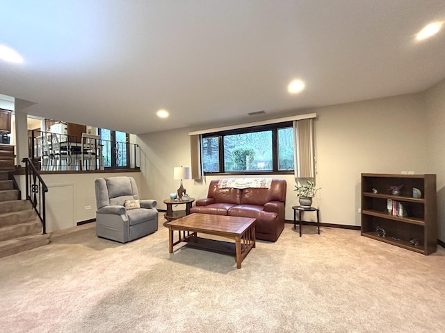 carpeted living area featuring stairway, baseboards, and recessed lighting
