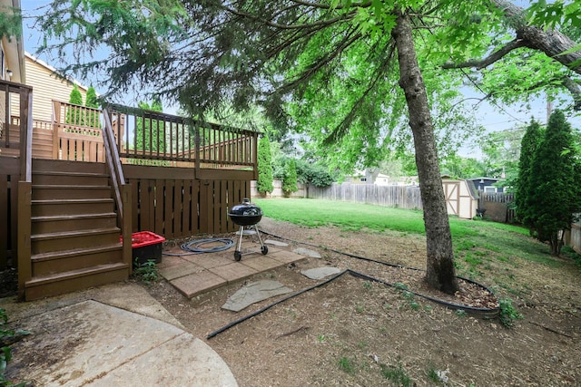 3110 Still Hill Dr, Mchenry, IL 60050 - fenced backyard with stairway, a storage unit, a wooden deck, and a patio area
