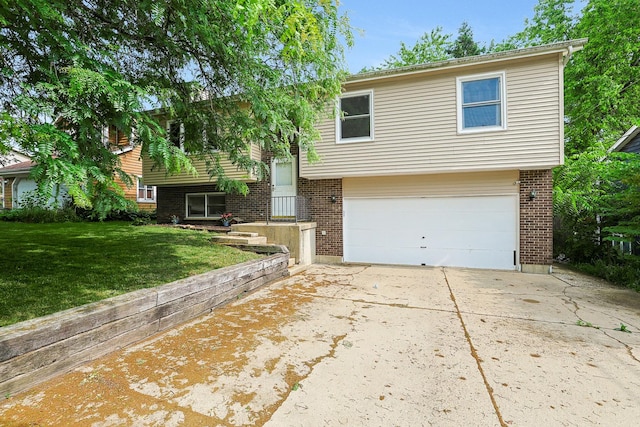 3110 Still Hill Dr, Mchenry, IL 60050 - split foyer home with an attached garage, a front yard, concrete driveway, and brick siding