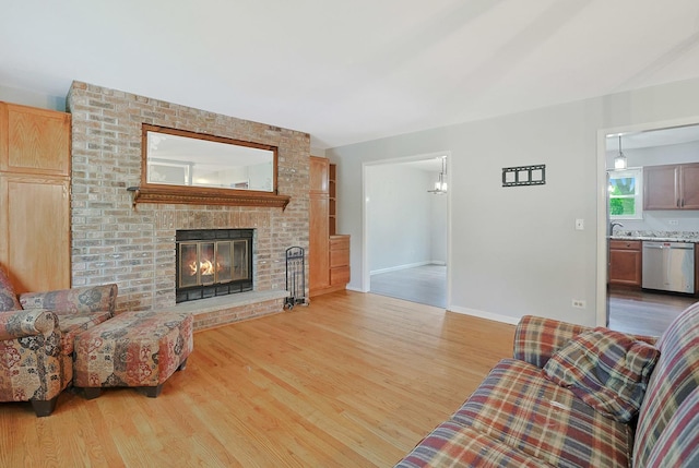 3110 Still Hill Dr, Mchenry, IL 60050 - living room featuring wood finished floors and a brick fireplace