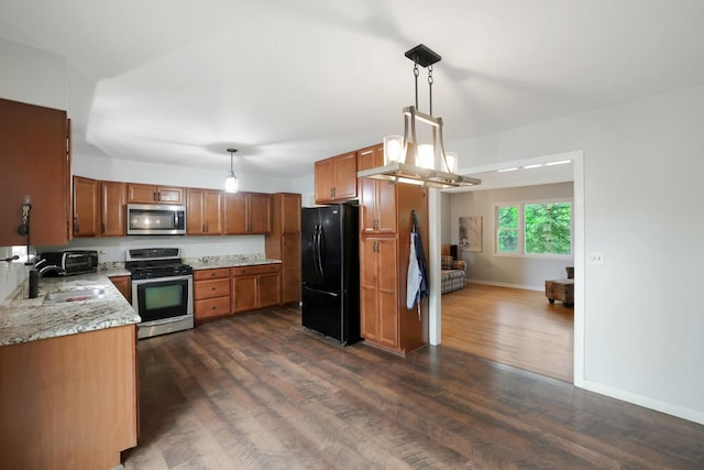 3110 Still Hill Dr, Mchenry, IL 60050 - kitchen with appliances with stainless steel finishes, brown cabinets, dark wood-type flooring, and decorative light fixtures