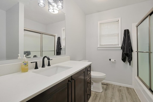 3110 Still Hill Dr, Mchenry, IL 60050 - bathroom with wood finished floors, vanity, and bath / shower combo with glass door