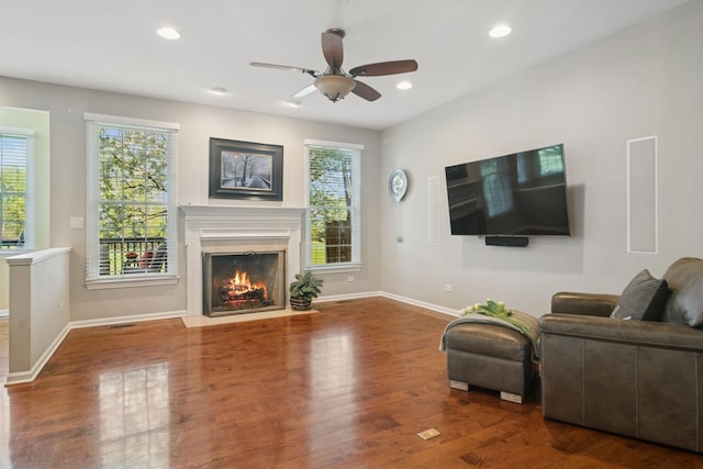 15 Red Tail Dr, Hawthorn Woods, IL 60047 - living room featuring a fireplace with flush hearth, wood finished floors, a ceiling fan, baseboards, and recessed lighting