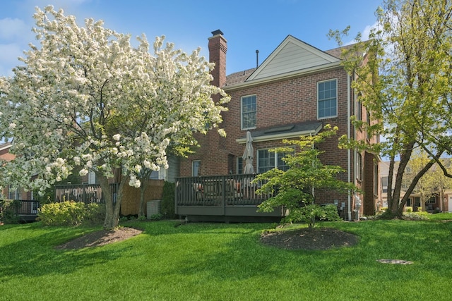 15 Red Tail Dr, Hawthorn Woods, IL 60047 - rear view of property featuring brick siding, a deck, a chimney, and a yard