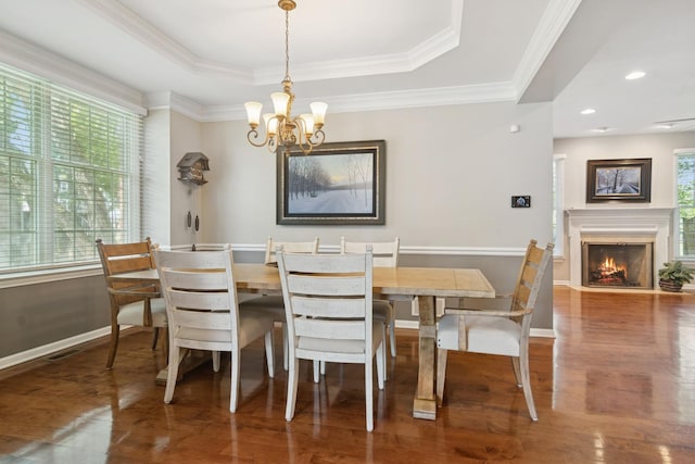 15 Red Tail Dr, Hawthorn Woods, IL 60047 - dining room featuring healthy amount of natural light, a raised ceiling, a chandelier, wood finished floors, and ornamental molding