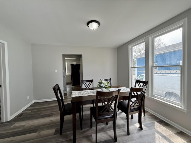 dining room with baseboards and dark wood finished floors
