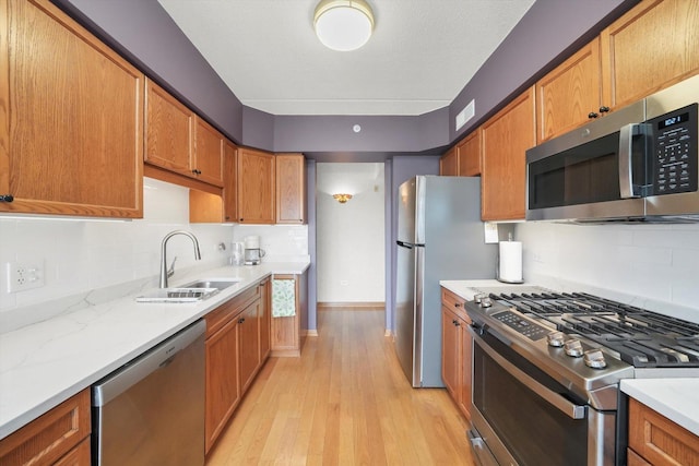 kitchen featuring visible vents, a sink, tasteful backsplash, and stainless steel appliances