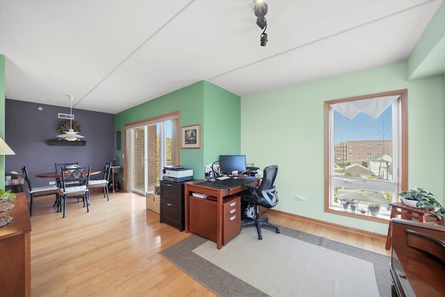 home office featuring visible vents, plenty of natural light, and wood finished floors