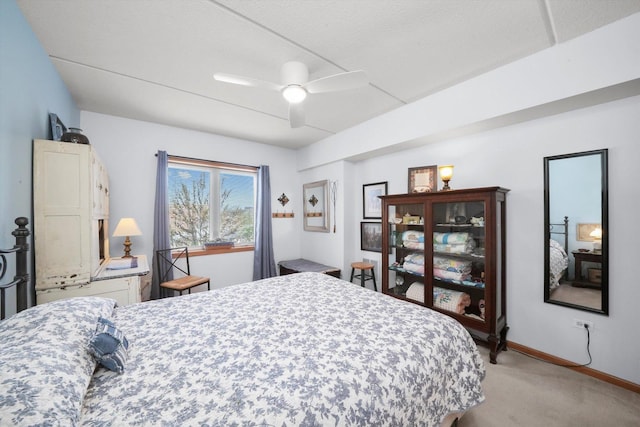 bedroom featuring a ceiling fan, baseboards, and light carpet