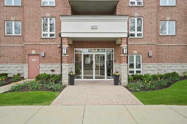 doorway to property with brick siding