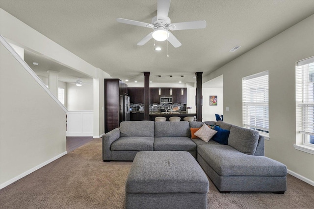 carpeted living area with a ceiling fan, decorative columns, plenty of natural light, a textured ceiling, and recessed lighting