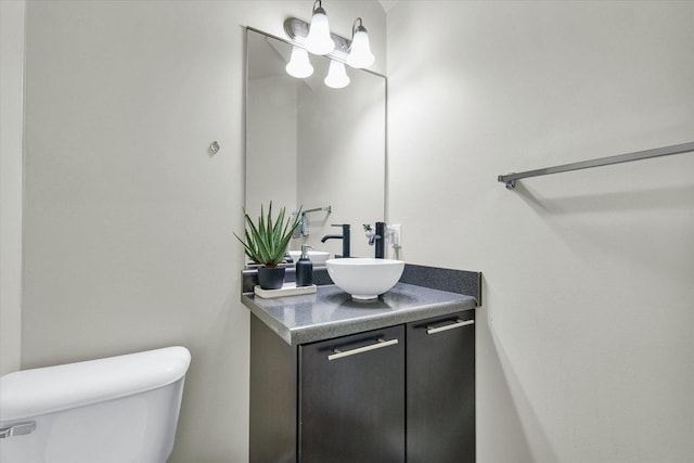 bathroom with toilet and vanity