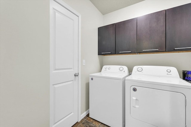 clothes washing area featuring cabinet space, separate washer and dryer, and baseboards
