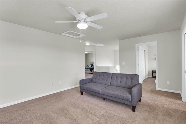 living area with carpet floors, ceiling fan, and baseboards