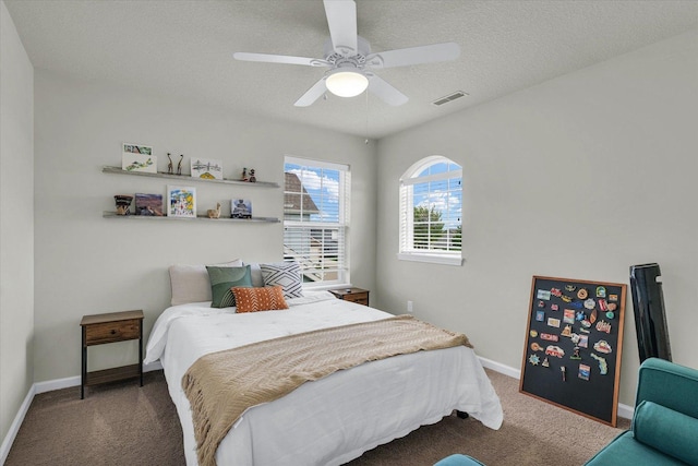 bedroom with carpet floors, baseboards, ceiling fan, and a textured ceiling