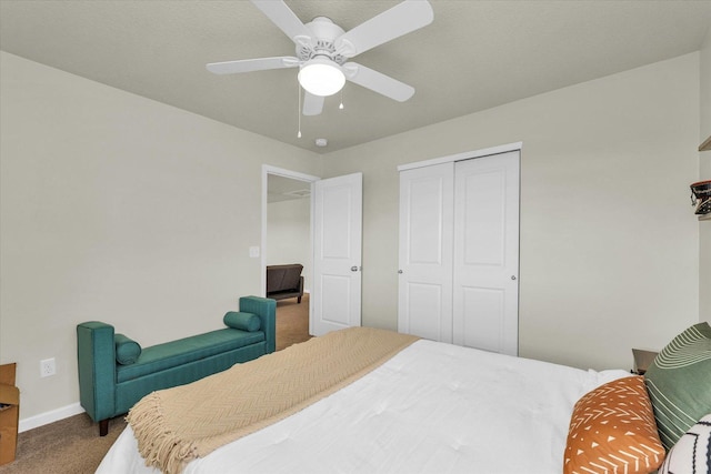 bedroom with carpet floors, a closet, baseboards, and ceiling fan