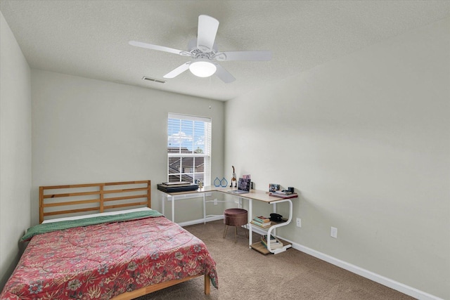 bedroom with carpet flooring, a textured ceiling, ceiling fan, and baseboards