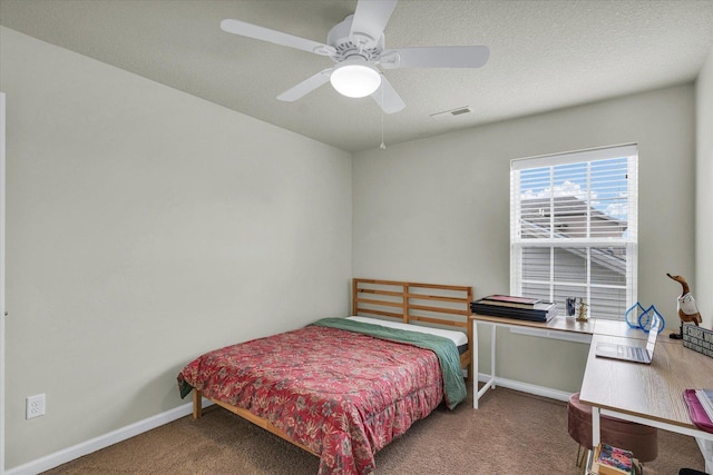carpeted bedroom featuring baseboards and ceiling fan