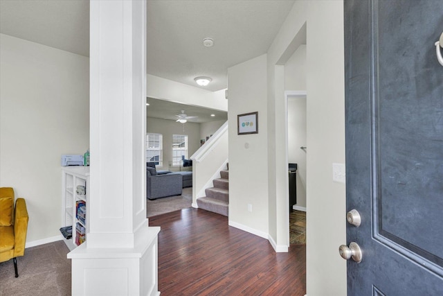 foyer featuring wood finished floors, stairs, baseboards, and ceiling fan