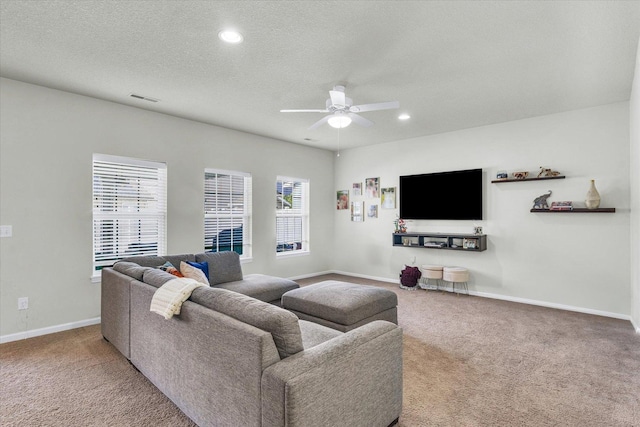 carpeted living area featuring ceiling fan, baseboards, a textured ceiling, and recessed lighting