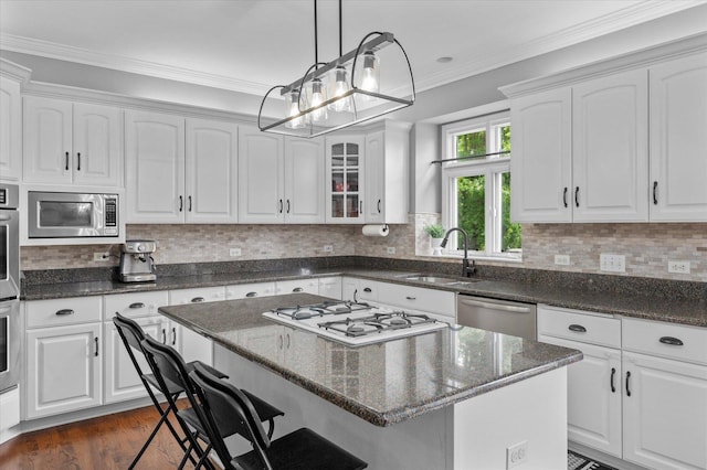 1759 Baybrook Ln, Naperville, IL 60564 - kitchen featuring a sink, stainless steel appliances, a kitchen breakfast bar, white cabinetry, and crown molding