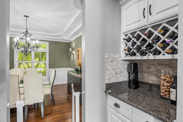 1759 Baybrook Ln, Naperville, IL 60564 - bar area with a chandelier, backsplash, dark wood-style flooring, decorative light fixtures, and ornamental molding