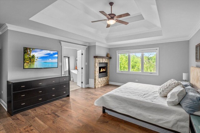 1759 Baybrook Ln, Naperville, IL 60564 - bedroom featuring a raised ceiling, wood finished floors, a fireplace, baseboards, and crown molding