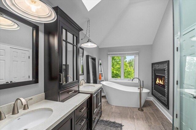 1759 Baybrook Ln, Naperville, IL 60564 - full bath featuring double vanity, a soaking tub, a glass covered fireplace, lofted ceiling, and a stall shower