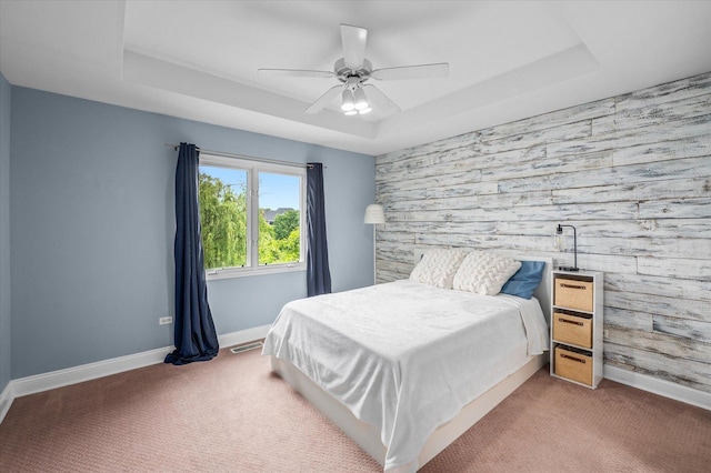 1759 Baybrook Ln, Naperville, IL 60564 - bedroom with an accent wall, a tray ceiling, baseboards, carpet floors, and wooden walls