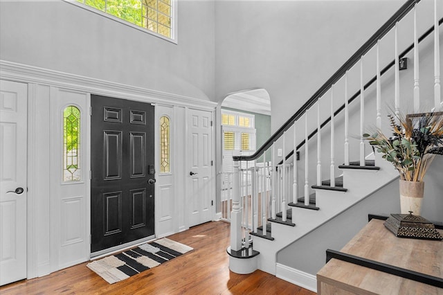 1759 Baybrook Ln, Naperville, IL 60564 - foyer with arched walkways, a towering ceiling, plenty of natural light, wood finished floors, and stairway