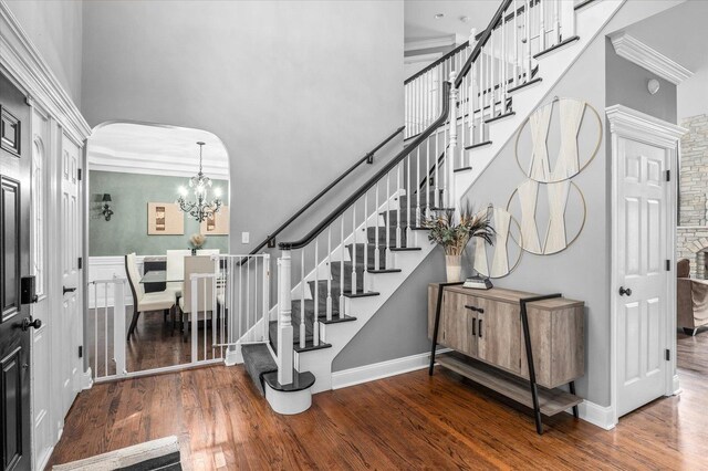 1759 Baybrook Ln, Naperville, IL 60564 - entrance foyer featuring a high ceiling, arched walkways, wood finished floors, stairs, and a chandelier