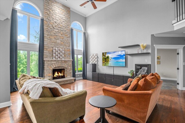 1759 Baybrook Ln, Naperville, IL 60564 - living area featuring a stone fireplace, ceiling fan, a towering ceiling, healthy amount of natural light, and ornamental molding