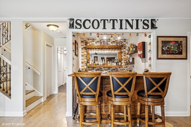 701 N Coolidge Ave, Palatine, IL 60067 - indoor dry bar featuring stairway, wood finished floors, and baseboards
