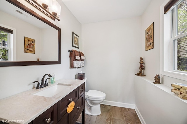 701 N Coolidge Ave, Palatine, IL 60067 - half bath with plenty of natural light, vanity, toilet, and baseboards