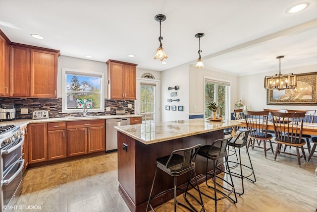 701 N Coolidge Ave, Palatine, IL 60067 - kitchen with appliances with stainless steel finishes, plenty of natural light, light wood-type flooring, light stone counters, and recessed lighting