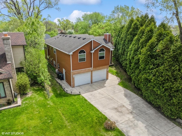 701 N Coolidge Ave, Palatine, IL 60067 - view of property exterior with concrete driveway, an attached garage, a chimney, roof with shingles, and a lawn