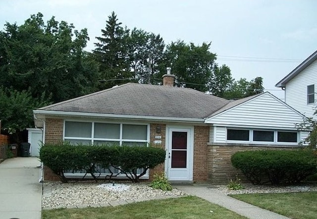 2041 175th St, Homewood, IL 60430 - view of front of house featuring a chimney, a front yard, roof with shingles, and brick siding