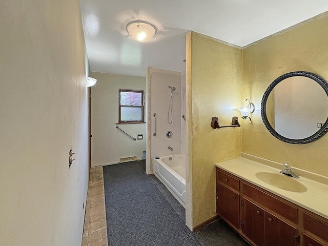 full bath featuring vanity, a textured wall, and shower / bathtub combination
