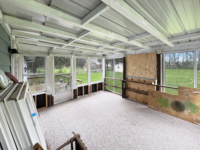 unfurnished sunroom featuring visible vents and beamed ceiling