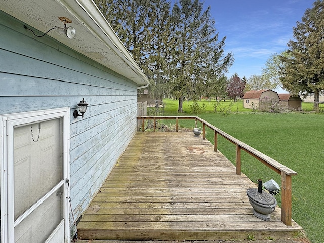wooden deck featuring a lawn