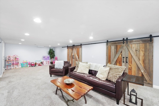 living area featuring a barn door, recessed lighting, and carpet floors