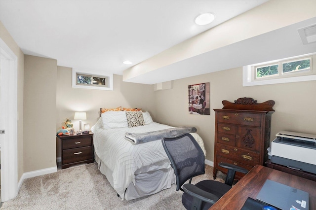 bedroom featuring light colored carpet and baseboards
