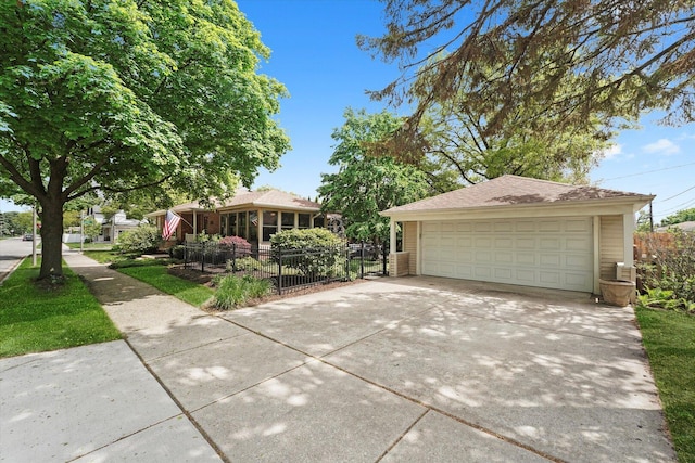 ranch-style home with a detached garage, fence, and an outdoor structure