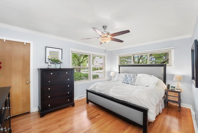 bedroom featuring light wood-type flooring, baseboards, crown molding, and a ceiling fan