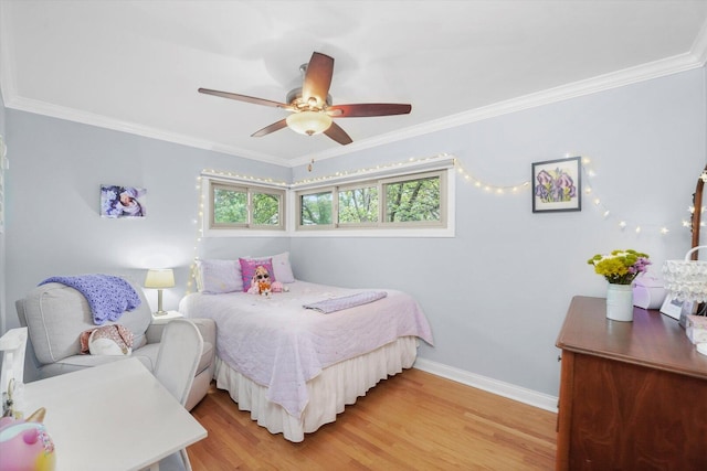 bedroom featuring light wood-type flooring, baseboards, ornamental molding, and a ceiling fan
