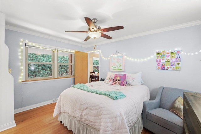 bedroom featuring crown molding, wood finished floors, baseboards, and a ceiling fan