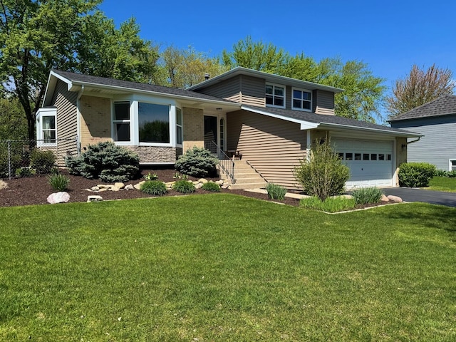 660 Londonberry Ln, Bolingbrook, IL 60440 - split level home featuring asphalt driveway, a front yard, and an attached garage