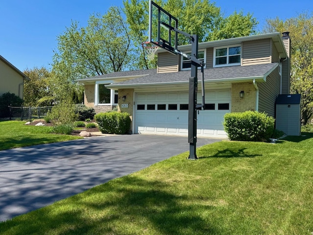 660 Londonberry Ln, Bolingbrook, IL 60440 - view of front of house with a chimney, driveway, and a shingled roof